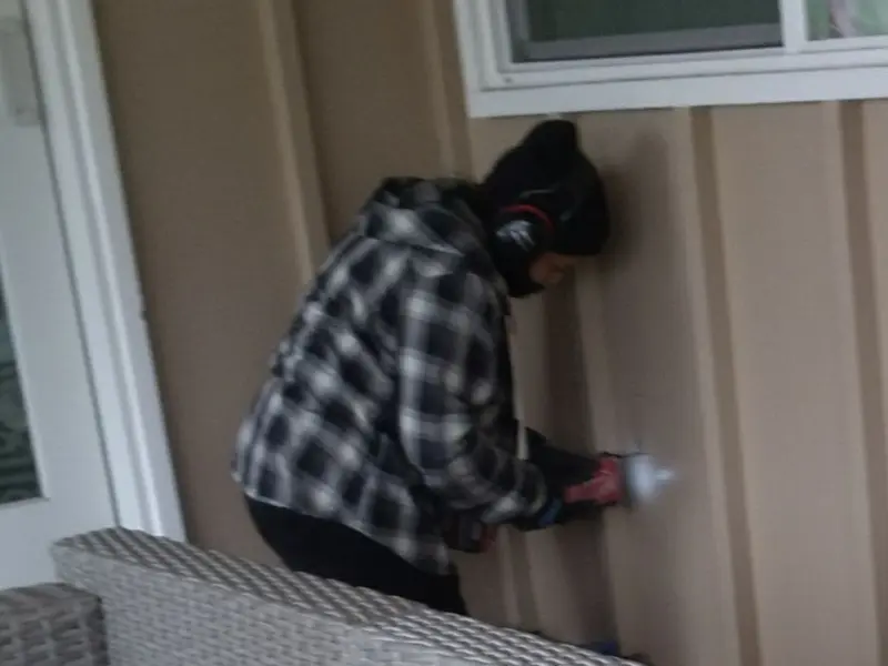 Professional electrician installing an exterior outlet in Clay